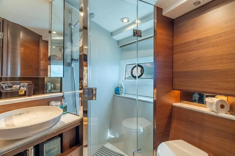 Slide: The Image of Luxurious bathroom on 2019 Princess F70 yacht with modern fixtures and wooden accents. - 8