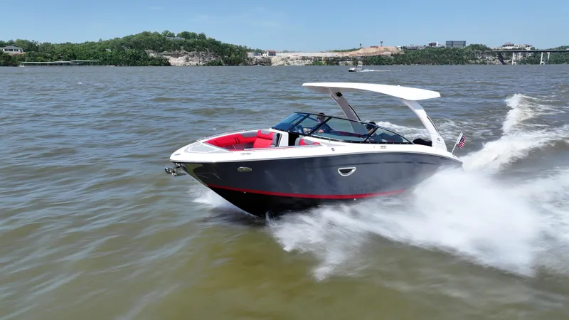 Slide: The Image of 2025 Regal LS9 boat cruising on a lake with scenic background. - 1