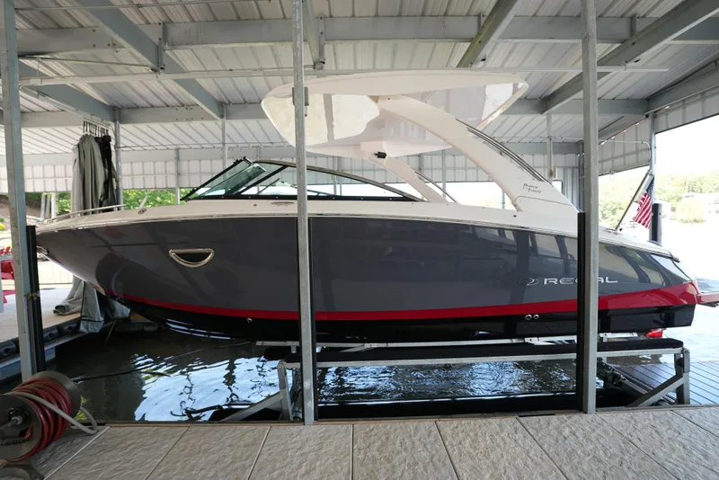Slide: The Image of 2025 Regal LS9 boat docked in a covered marina. - 14
