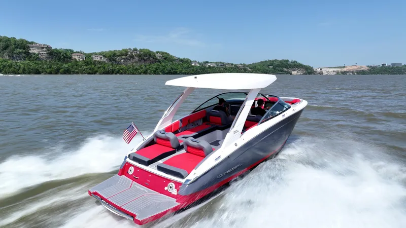 Slide: The Image of 2025 Regal LS9 boat cruising on a lake, featuring sleek design and vibrant red interior. - 2