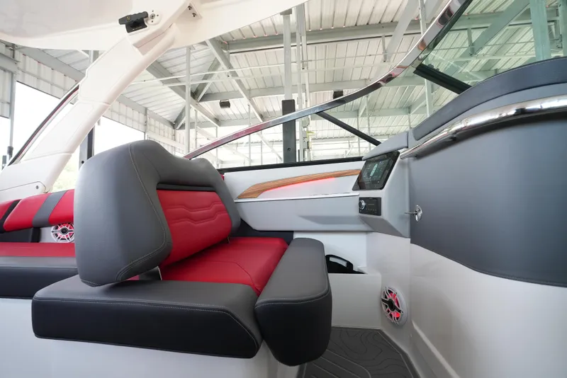 Slide: The Image of 2025 Regal LS9 boat interior with red and gray seating, modern dashboard, and sleek design. - 33