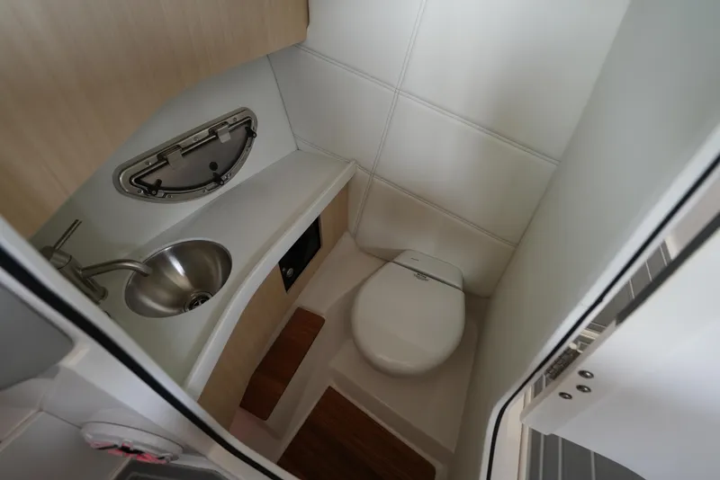 Slide: The Image of 2025 Regal LS9 boat bathroom with sink, toilet, and wooden accents. - 34