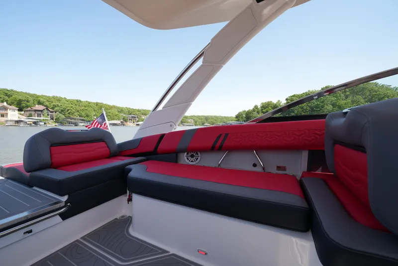 Slide: The Image of 2025 Regal LS9 boat interior with red and black seating, lake view in background. - 39