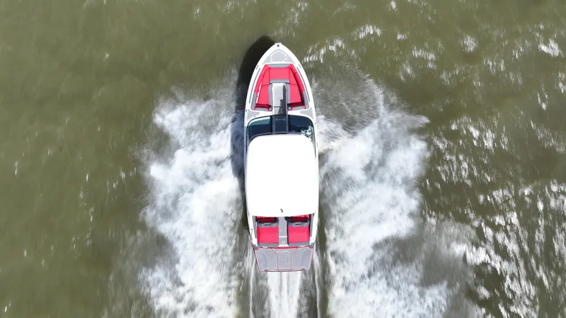 Slide: The Image of Aerial view of 2025 Regal LS9 boat speeding on water, creating white wake. - 5