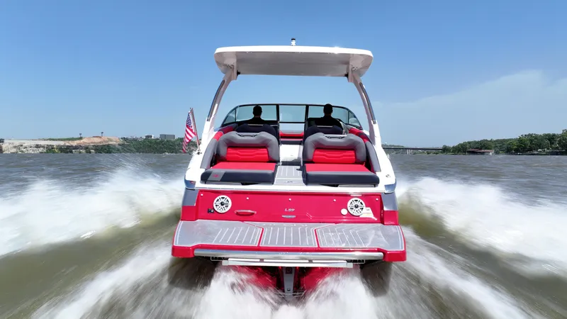 Slide: The Image of 2025 Regal LS9 boat cruising on a sunny day, rear view with wake. - 6