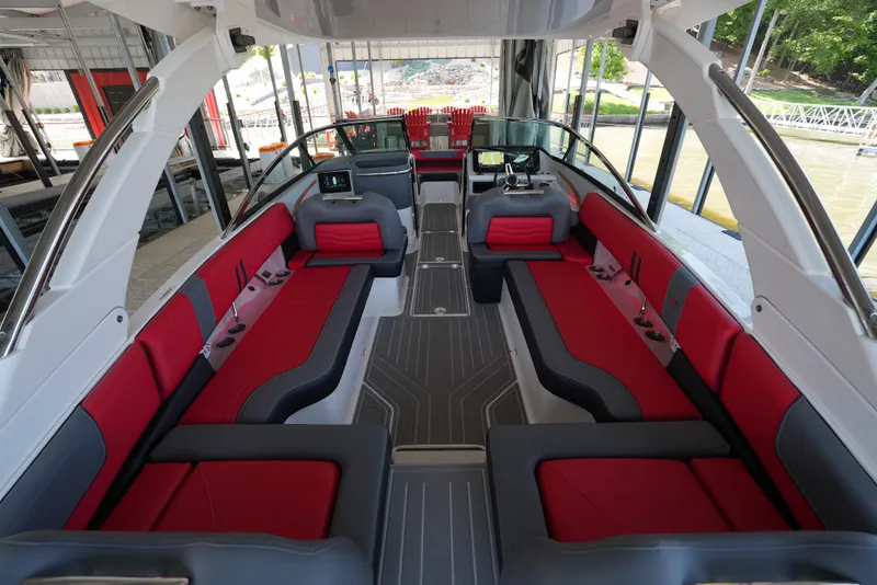Slide: The Image of Luxurious 2025 Regal LS9 boat interior with red and gray seating, docked in a marina. - 9