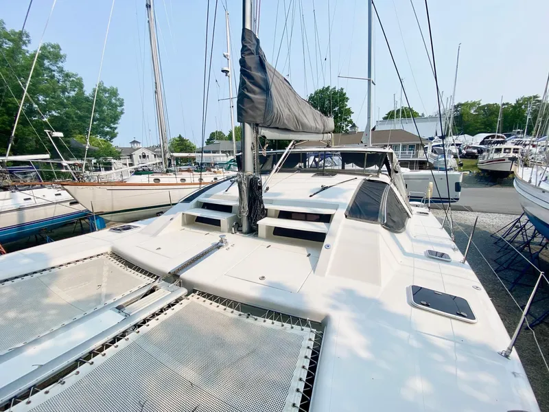 Slide: The Image of 2016 Celtic Yachts 40 catamaran docked at a marina, surrounded by other boats. - 19