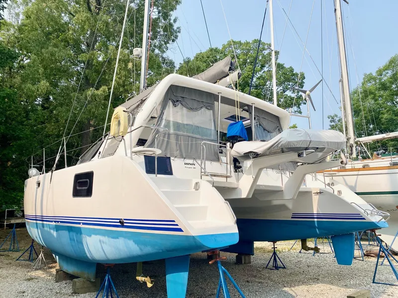 Slide: The Image of 2016 Celtic Yachts 40 catamaran on stands, blue and white hull, outdoor setting. - 3