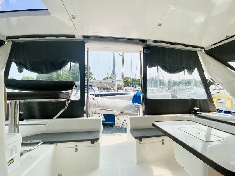 Slide: The Image of Interior view of 2016 Celtic Yachts 40, featuring seating and table, with marina backdrop. - 30