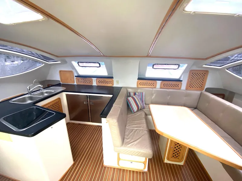 Slide: The Image of Interior of 2016 Celtic Yachts 40, featuring a modern kitchen and cozy dining area. - 34