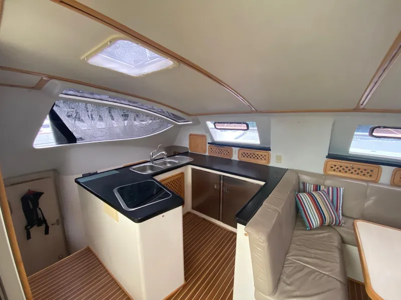 Slide: The Image of Interior of 2016 Celtic Yachts 40, featuring a modern kitchen and cozy seating area. - 37