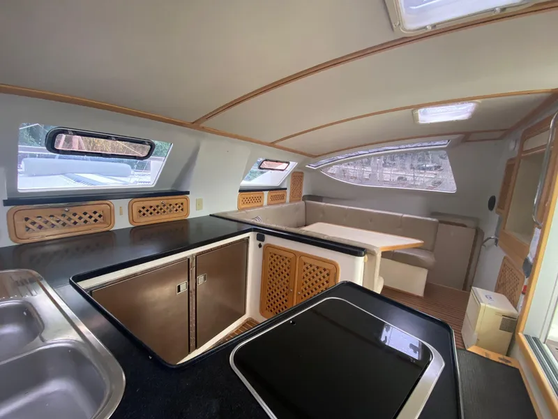 Slide: The Image of Interior of 2016 Celtic Yachts 40, featuring modern kitchen and dining area with ample natural light. - 41