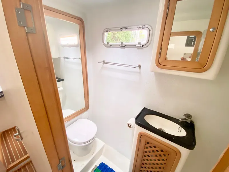 Slide: The Image of Bathroom interior of 2016 Celtic Yachts 40, featuring sink, toilet, and wooden accents. - 48