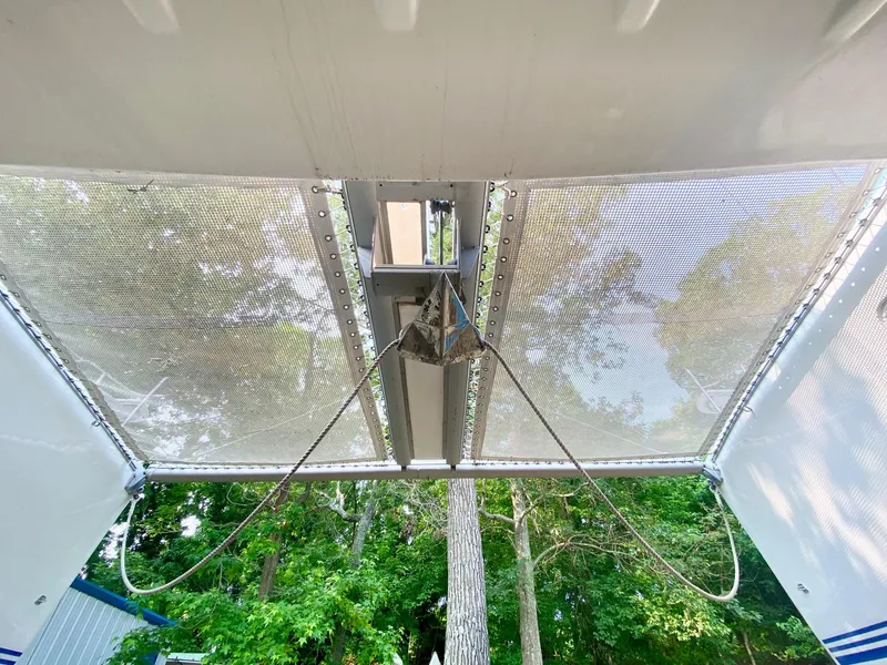 Slide: The Image of View of 2016 Celtic Yachts 40 catamaran netting with trees in the background. - 7