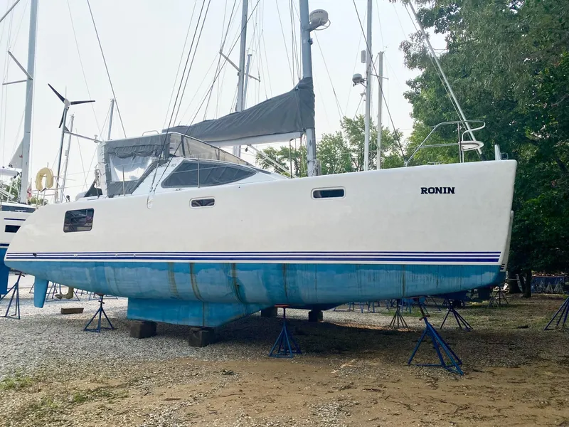 Slide: The Image of 2016 Celtic Yachts 40 sailboat on stands, white hull with blue stripe, named "Ronin." - 11