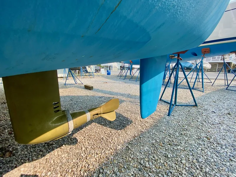 Slide: The Image of Celtic Yachts 40, 2016 model, hull and propeller on gravel, supported by stands. - 13