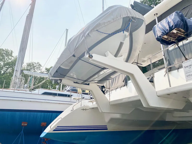 Slide: The Image of Celtic Yachts 40, 2016 model, with a covered dinghy on davits, docked in a marina. - 15