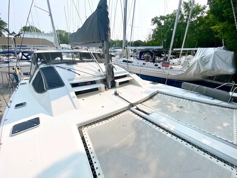 Slide: The Image of 2016 Celtic Yachts 40 sailboat docked, featuring spacious deck and netting, surrounded by other boats. - 17