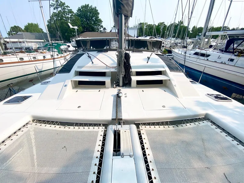 Slide: The Image of 2016 Celtic Yachts 40 catamaran docked, showcasing spacious deck and netting. - 18