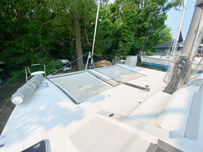 Slide: The Image of 2016 Celtic Yachts 40 catamaran deck with netting, surrounded by lush greenery. - 23