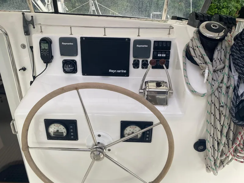 Slide: The Image of Steering wheel and control panel of 2016 Celtic Yachts 40 sailboat with navigation equipment. - 33