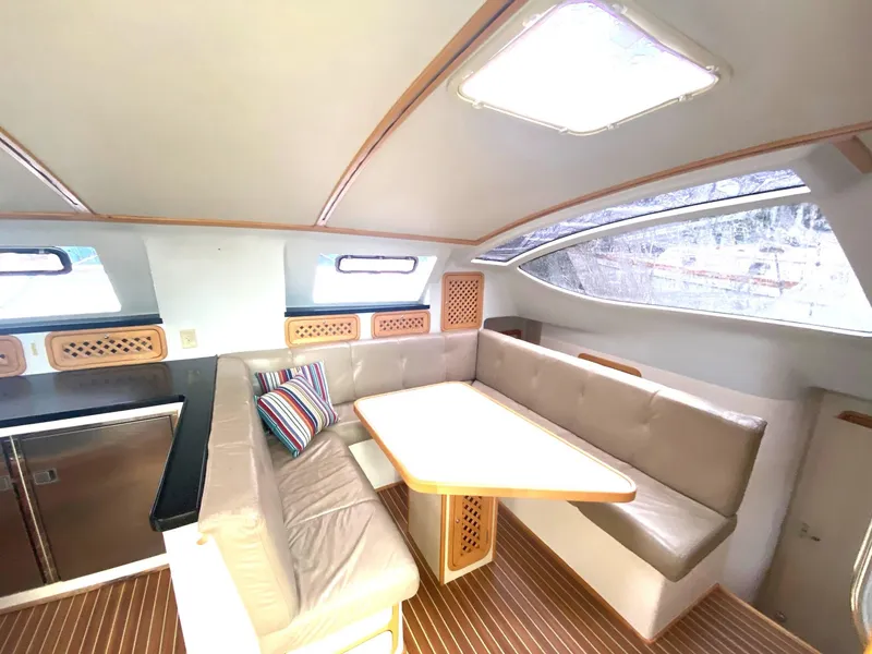 Slide: The Image of Interior of 2016 Celtic Yachts 40, featuring a cozy seating area with a table. - 35