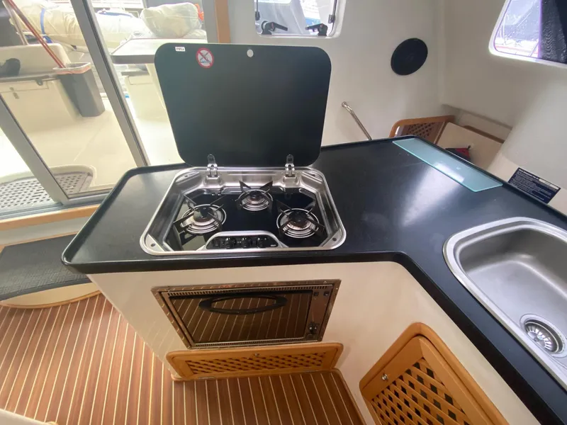 Slide: The Image of Celtic Yachts 40 (2016) kitchen area with stove, sink, and wooden flooring. - 39