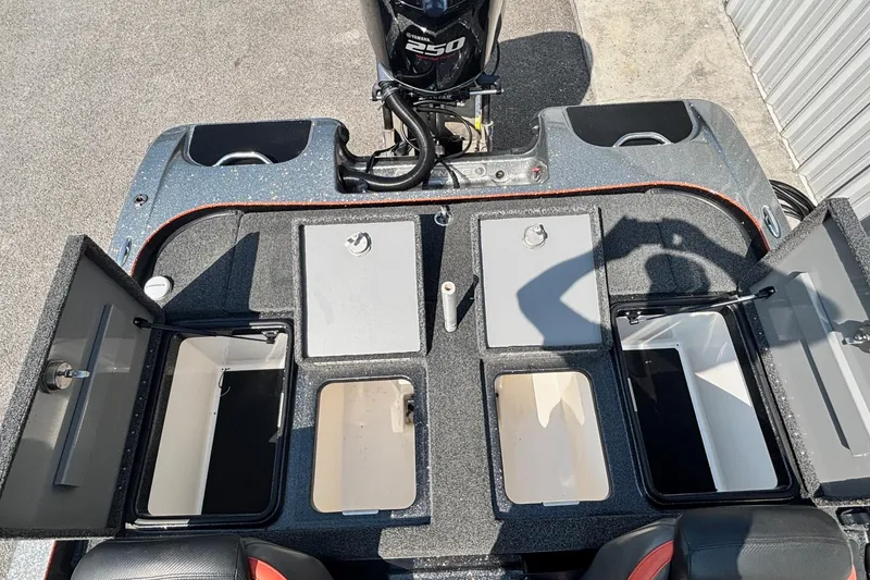 Slide: The Image of 2020 Caymas CX21 boat storage compartments and engine, showcasing ample space and organization. - 12