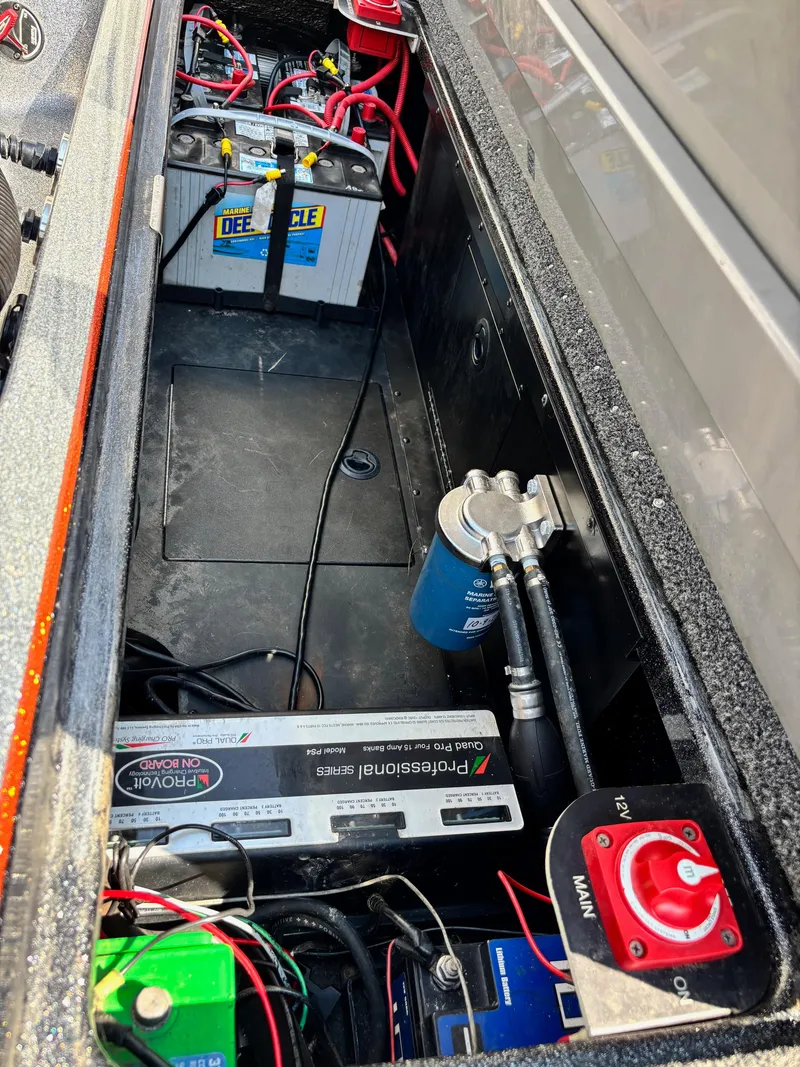 Slide: The Image of 2020 Caymas CX21 boat battery compartment with wiring and components. - 14