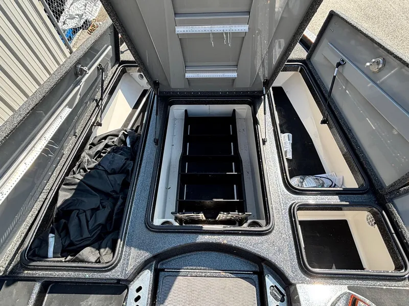 Slide: The Image of 2020 Caymas CX21 boat storage compartments open, showcasing organized interior layout. - 7