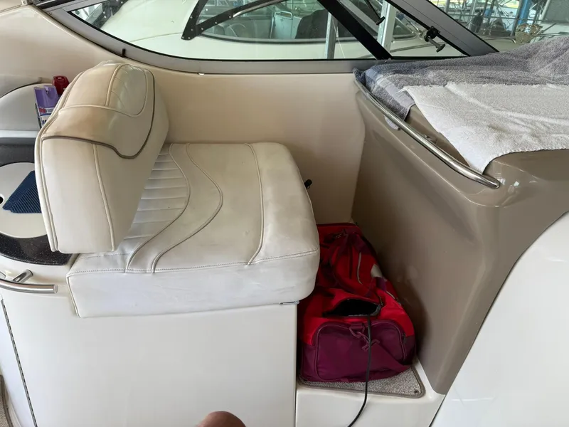 Slide: The Image of 2000 Maxum 3700 SCR boat interior with white seating and red bag. - 12