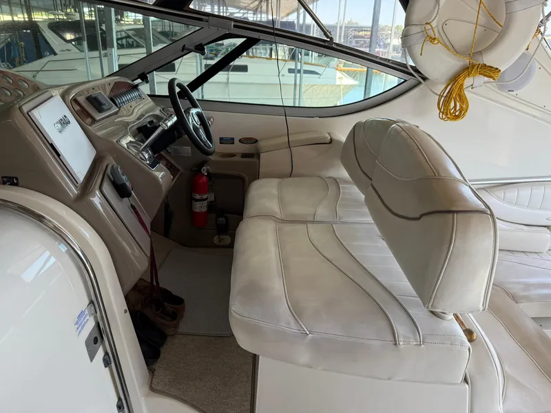 Slide: The Image of 2000 Maxum 3700 SCR boat interior with beige seating and steering console. - 13