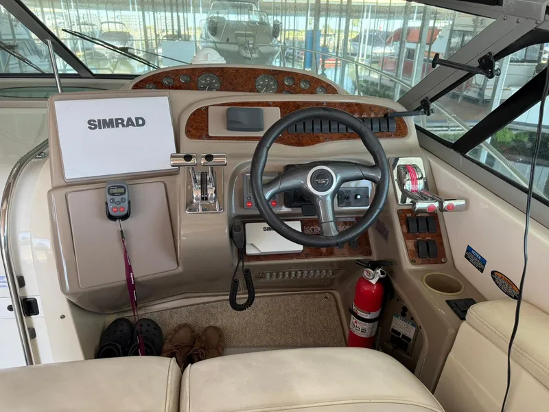 Slide: The Image of Cockpit of 2000 Maxum 3700 SCR boat with steering wheel and navigation equipment. - 14