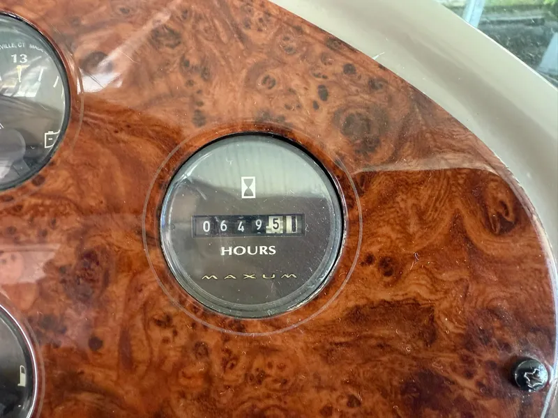 Slide: The Image of Maxum 3700 SCR 2000 hour meter showing 649.51 hours on wood grain dashboard. - 17