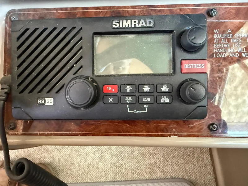 Slide: The Image of Simrad RS35 marine radio on a 2000 Maxum 3700 SCR boat dashboard. - 19