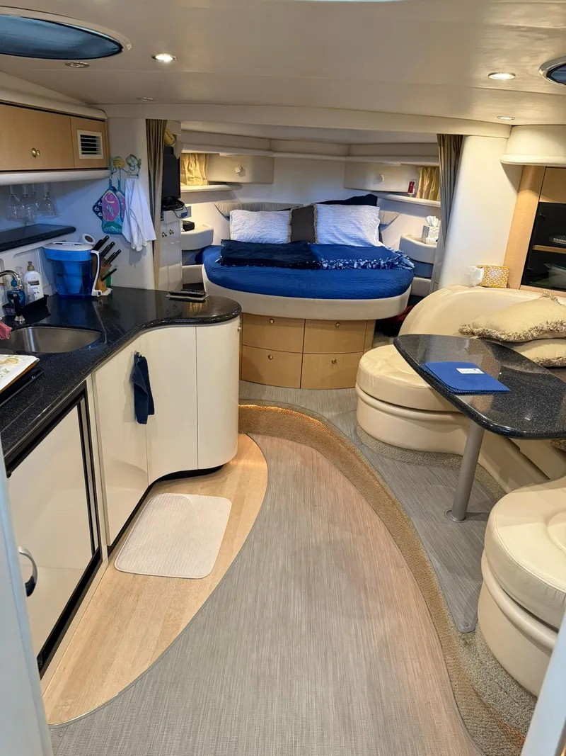 Slide: The Image of Interior of 2000 Maxum 3700 SCR yacht with modern kitchen and cozy sleeping area. - 27