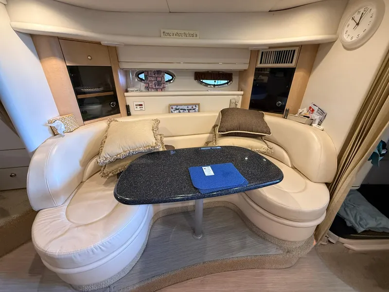 Slide: The Image of Interior of 2000 Maxum 3700 SCR yacht with plush seating and elegant table. - 29