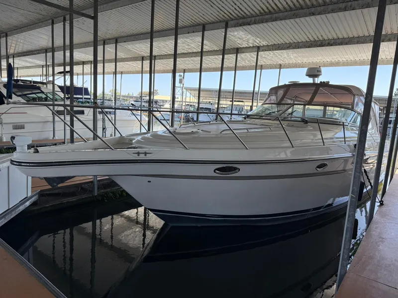 Slide: The Image of 2000 Maxum 3700 SCR yacht docked in a covered marina. - 3