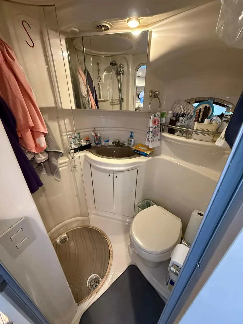 Slide: The Image of Compact bathroom in 2000 Maxum 3700 SCR yacht with shower, sink, and toilet. - 31