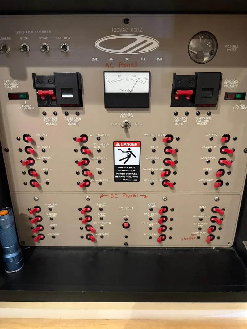 Slide: The Image of Electrical control panel of a 2000 Maxum 3700 SCR boat with switches and gauges. - 39