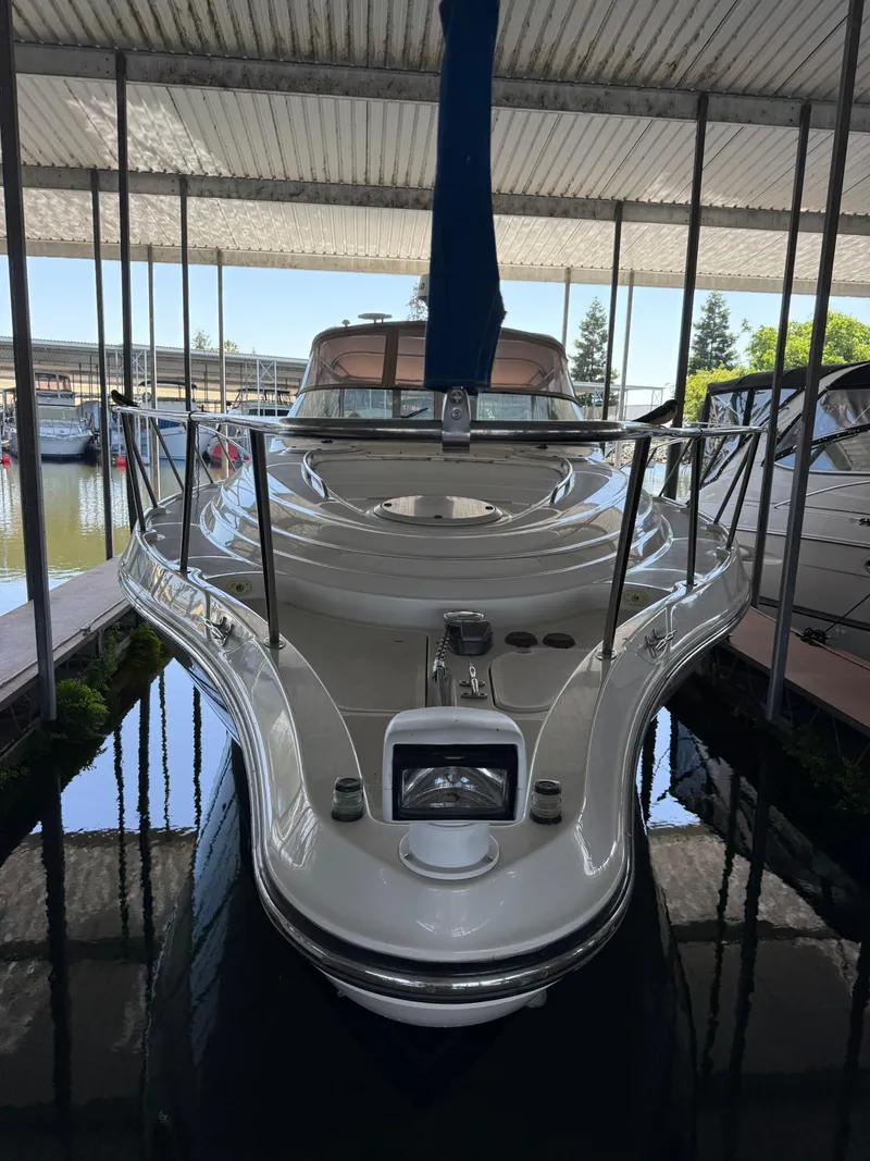 Slide: The Image of 2000 Maxum 3700 SCR yacht docked in a covered marina. - 4