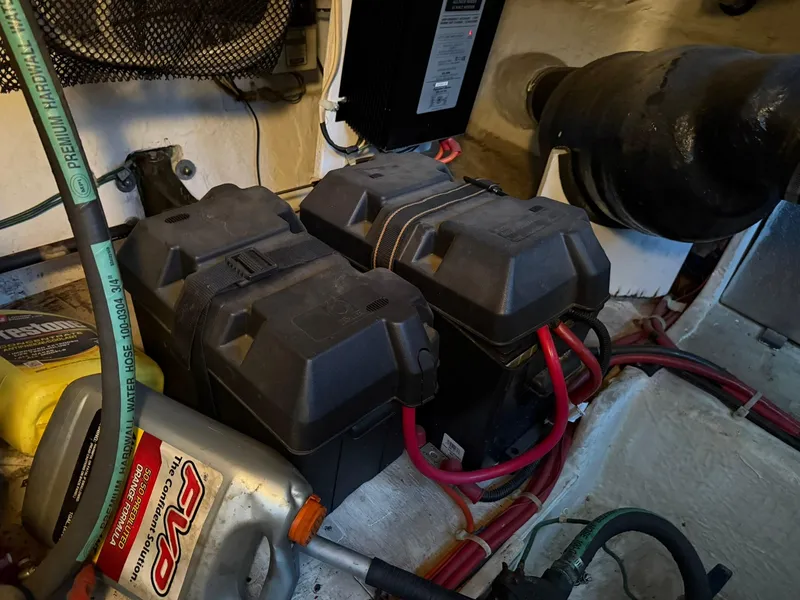 Slide: The Image of Battery compartment of a 2000 Maxum 3700 SCR boat with cables and maintenance supplies. - 44