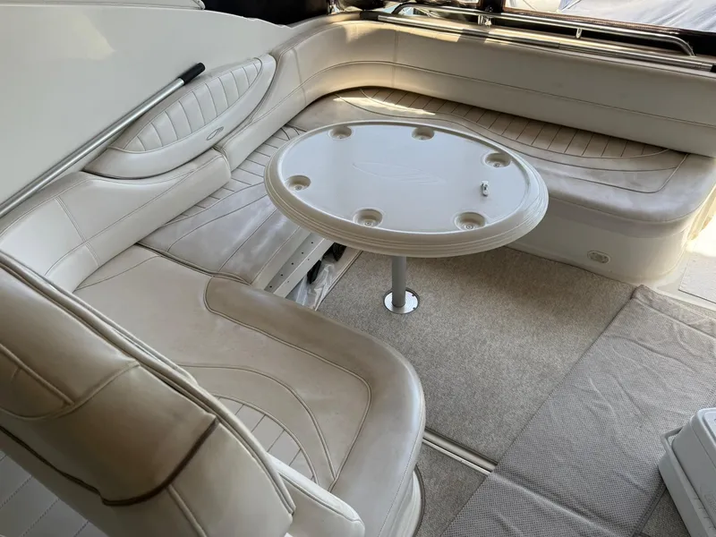 Slide: The Image of Interior of 2000 Maxum 3700 SCR boat with beige seating and round table. - 7