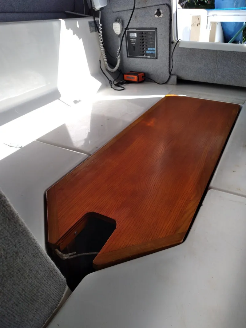 Slide: The Image of Interior of 2004 Corsair F-24MKII sailboat with wooden table and control panel. - 13