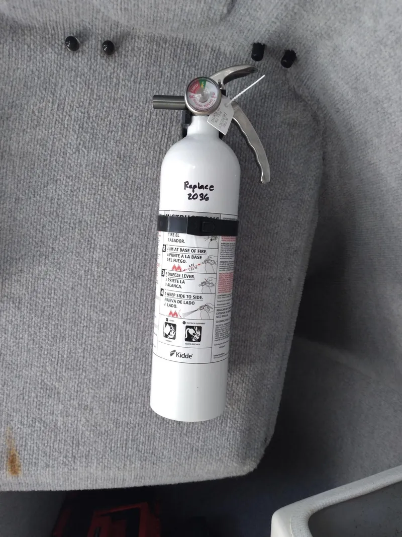 Slide: The Image of White fire extinguisher mounted on a Corsair F-24MKII, 2004 model, with replacement date noted. - 14