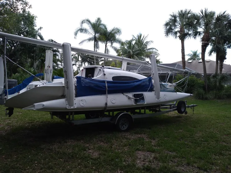 Slide: The Image of 2004 Corsair F-24MKII sailboat on trailer, surrounded by palm trees. - 3