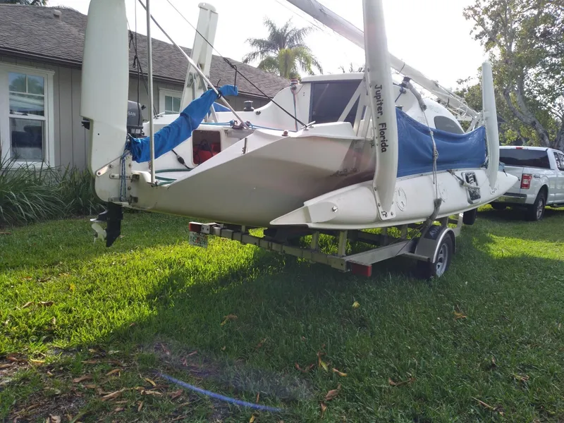 Slide: The Image of 2004 Corsair F-24MKII sailboat on trailer, parked on grass near house. - 6