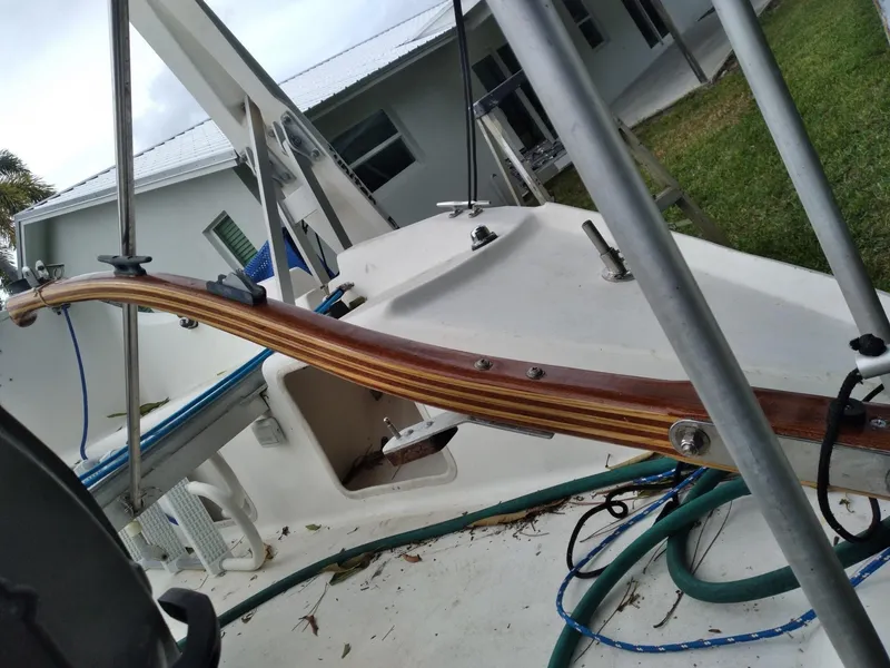 Slide: The Image of 2004 Corsair F-24MKII sailboat deck with wooden tiller and metal supports. - 9