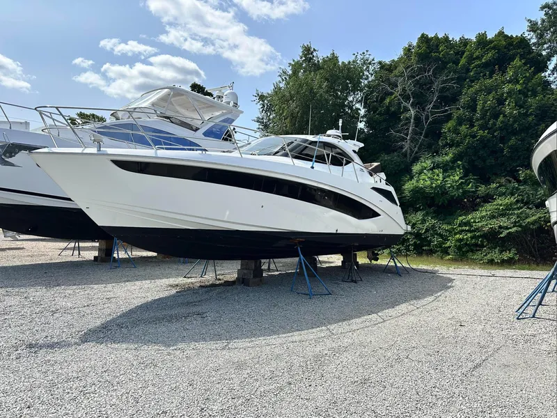 Slide: The Image of 2018 Galeon 385 HTS yacht on stands, surrounded by trees and blue sky. - 1
