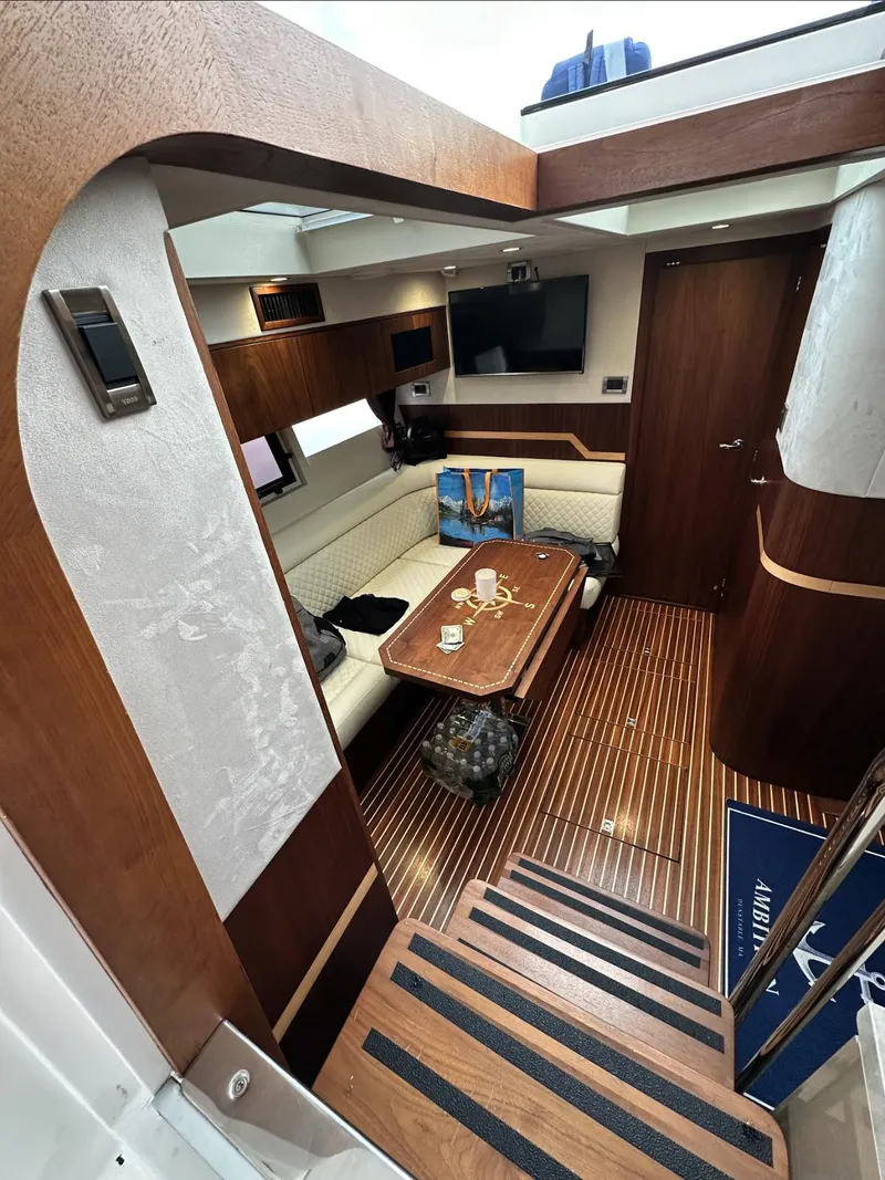 Slide: The Image of Interior of 2018 Galeon 385 HTS yacht with elegant wood finish and cozy seating area. - 12